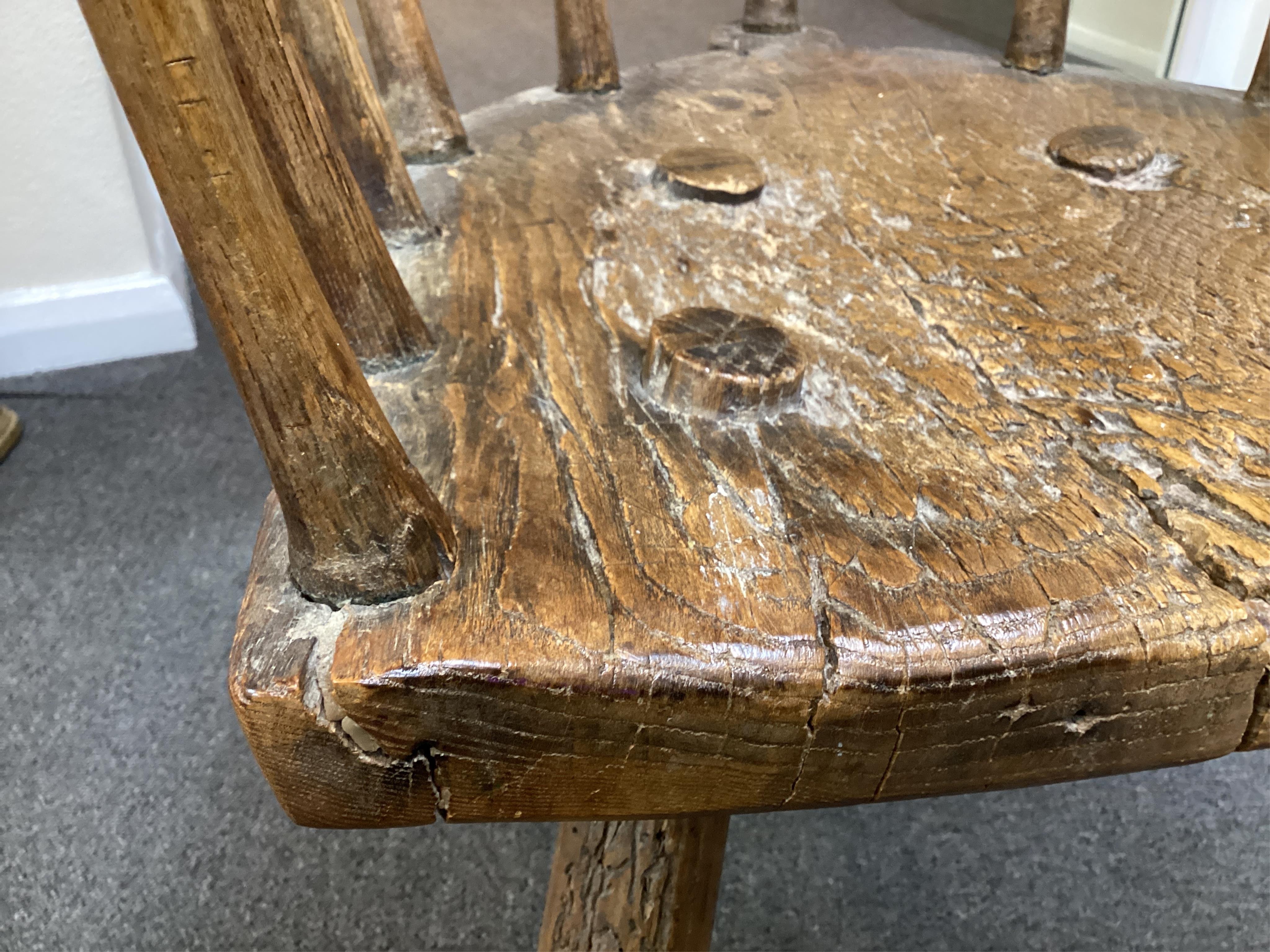 An 18th or 19th century primitive ash and elm Windsor armchair